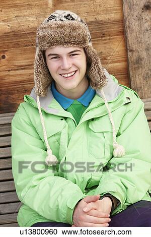 Teenage Boy Dressed For Cold Weather Sitting On Wooden Bench View Large Photo Image Stock Image - Teenage Boy Dressed For Cold Weather Sitting On Wooden Bench. Fotosearch