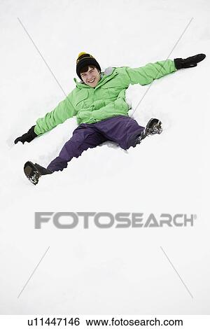 Teenage Boy Making Snow Angel On Slope View Large Photo Image Stock Photograph - Teenage Boy Making Snow Angel On Slope. Fotosearch