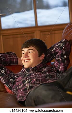 Stock Photography - Teenage Boy Relaxing On Sofa. Fotosearch