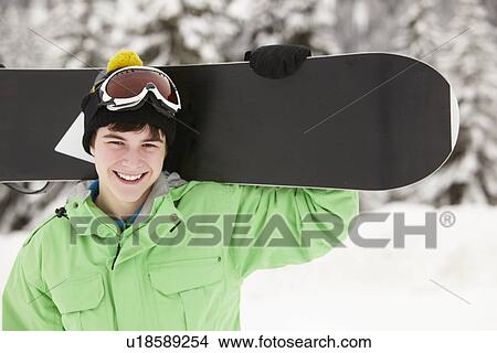 Teenage Boy With Snowboard On Ski Holiday In Mountains View Large Photo Image Picture - Teenage Boy With Snowboard On Ski Holiday In Mountains. Fotosearch