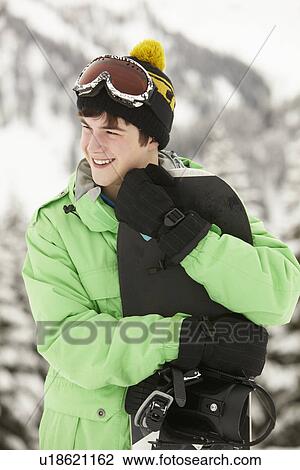 Teenage Boy With Snowboard On Ski Holiday In Mountains View Large Photo Image Stock Image - Teenage Boy With Snowboard On Ski Holiday In Mountains. Fotosearch