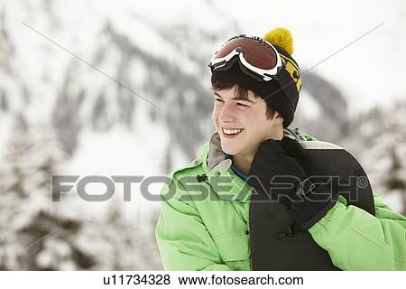 Teenage Boy With Snowboard On Ski Holiday In Mountains View Large Photo Image Stock Photo - Teenage Boy With Snowboard On Ski Holiday In Mountains. Fotosearch