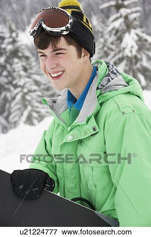 Teenage Boy With Snowboard On Ski Holiday In Mountains View Large Photo Image Stock Photo - Teenage Boy With Snowboard On Ski Holiday In Mountains. Fotosearch