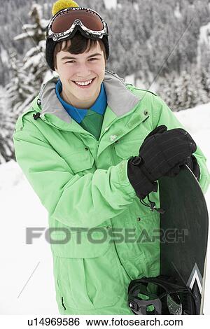 Teenage Boy With Snowboard On Ski Holiday In Mountains View Large Photo Image Stock Photograph - Teenage Boy With Snowboard On Ski Holiday In Mountains. Fotosearch