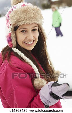 Teenage Couple Having Snowball Fight Wearing Fur Hats View Large Photo Image Stock Photo - Teenage Couple Having Snowball Fight Wearing Fur Hats. Fotosearch