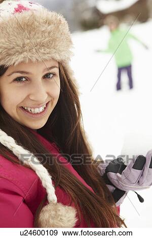 Teenage Couple Having Snowball Fight Wearing Fur Hats View Large Photo Image Stock Photo - Teenage Couple Having Snowball Fight Wearing Fur Hats. Fotosearch