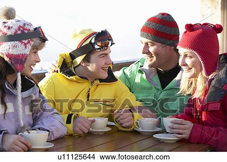 Teenage Family Enjoying Hot Drink In Café At Ski Resort View Large Photo Image Picture - Teenage Family Enjoying Hot Drink In Café At Ski Resort. Fotosearch