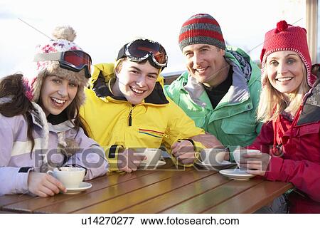 Teenage Family Enjoying Hot Drink In Café At Ski Resort View Large Photo Image Stock Photo - Teenage Family Enjoying Hot Drink In Café At Ski Resort. Fotosearch