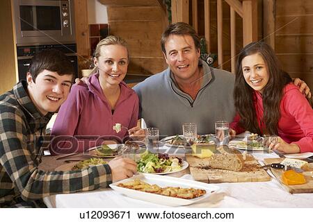 Teenage Family Enjoying Meal In Alpine Chalet Together View Large Photo Image Stock Image - Teenage Family Enjoying Meal In Alpine Chalet Together. Fotosearch