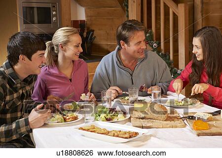 Teenage Family Enjoying Meal In Alpine Chalet Together View Large Photo Image Stock Photograph - Teenage Family Enjoying Meal In Alpine Chalet Together. Fotosearch
