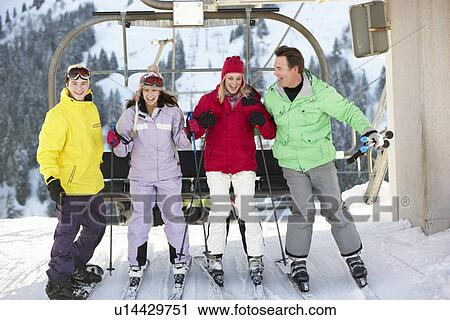 Teenage Family Getting Off chair Lift On Ski Holiday In Mountains View Large Photo Image Stock Image - Teenage Family Getting Off chair Lift On Ski Holiday In Mountains. Fotosearch