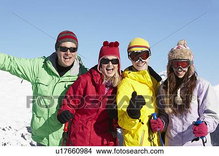 Picture - Teenage Family On Ski Holiday In Mountains. Fotosearch