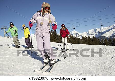 Stock Image - Teenage Family On Ski Holiday In Mountains. Fotosearch