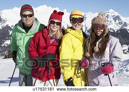 Stock Image - Teenage Family On Ski Holiday In Mountains. Fotosearch