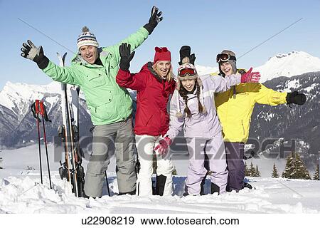 Stock Photo - Teenage Family On Ski Holiday In Mountains. Fotosearch