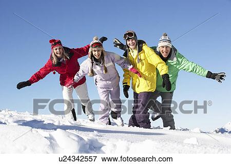 Stock Photo - Teenage Family On Ski Holiday In Mountains. Fotosearch