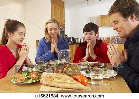 Teenage Family Saying Grace Before Eating Lunch Together In Kitchen View Large Photo Image Picture - Teenage Family Saying Grace Before Eating Lunch Together In Kitchen. Fotosearch