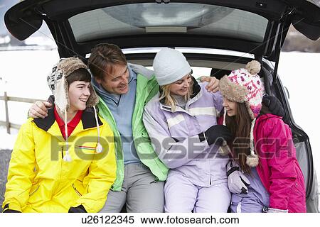 Teenage Family Sitting In Boot Of Car Wearing Winter Clothes View Large Photo Image Stock Photography - Teenage Family Sitting In Boot Of Car Wearing Winter Clothes. Fotosearch