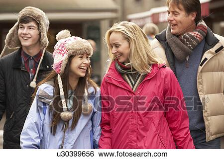 Teenage Family Walking Along Snowy Town Street In Ski Resort View Large Photo Image Stock Photograph - Teenage Family Walking Along Snowy Town Street In Ski Resort. Fotosearch