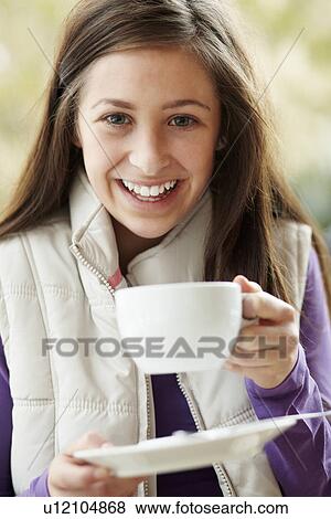 Teenage Girl In Outdoor Café With Hot Drink Wearing Winter Clothes View Large Photo Image Stock Photo - Teenage Girl In Outdoor Café With Hot Drink Wearing Winter Clothes. Fotosearch