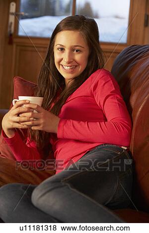 Teenage Girl Relaxing On Sofa With Hot Drink View Large Photo Image Stock Photo - Teenage Girl Relaxing On Sofa With Hot Drink. Fotosearch