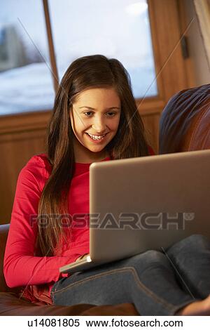 Teenage Girl Relaxing On Sofa With Laptop View Large Photo Image Stock Photography - Teenage Girl Relaxing On Sofa With Laptop. Fotosearch