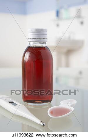Stock Image - Thermometer and medicine on bathroom shelf. Fotosearch