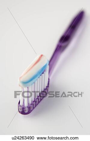 Stock Image - Toothbrush loaded with toothpaste. Fotosearch