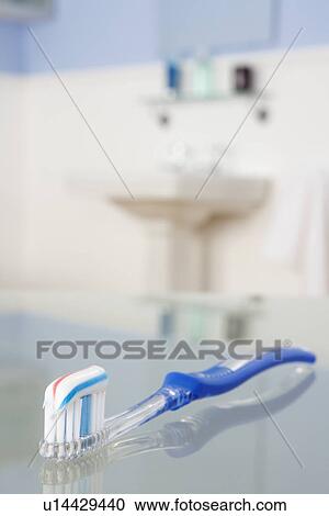 Stock Image - Toothbrush with toothpaste in bathroom. Fotosearch