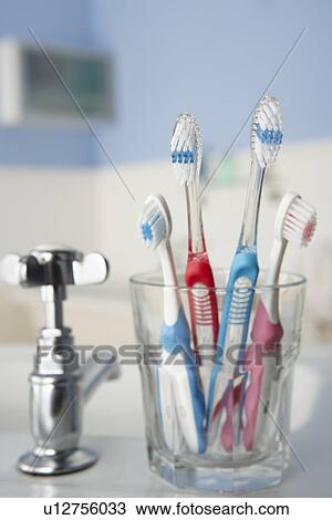 Stock Image - Toothbrushes in bathroom. Fotosearch