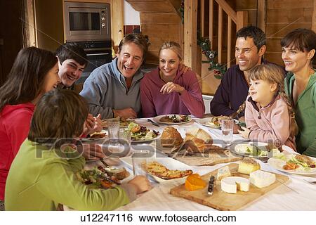 Two Familes Enjoying Meal In Alpine Chalet Together View Large Photo Image Stock Photograph - Two Familes Enjoying Meal In Alpine Chalet Together. Fotosearch