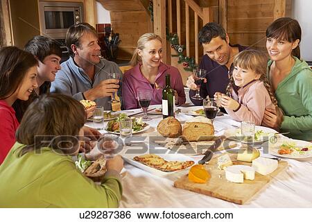 Two Familes Enjoying Meal In Alpine Chalet Together View Large Photo Image Stock Photograph - Two Familes Enjoying Meal In Alpine Chalet Together. Fotosearch