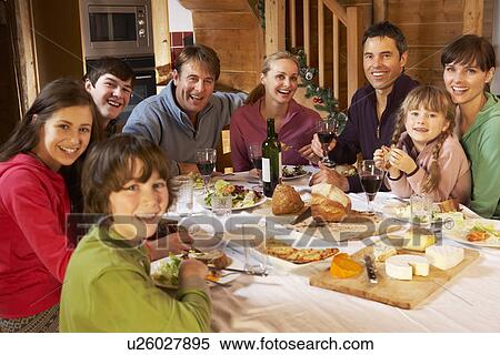 Two Familes Enjoying Meal In Alpine Chalet Together View Large Photo Image Stock Photography - Two Familes Enjoying Meal In Alpine Chalet Together. Fotosearch