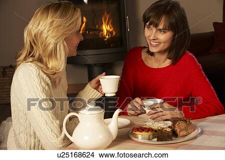 Picture - Two Middle Aged Women Enjoying Tea And Cake Together. Fotosearch