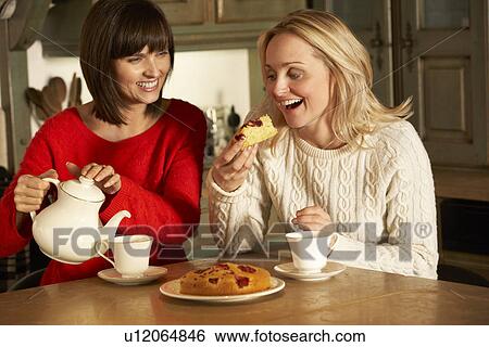 Two Middle Aged Women Enjoying Tea And Cake Together View Large Photo Image Stock Photograph - Two Middle Aged Women Enjoying Tea And Cake Together. Fotosearch