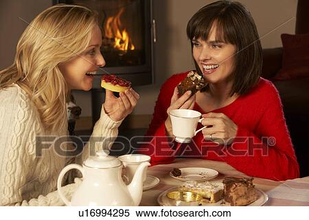 Two Middle Aged Women Enjoying Tea And Cake Together View Large Photo Image Stock Photography - Two Middle Aged Women Enjoying Tea And Cake Together. Fotosearch