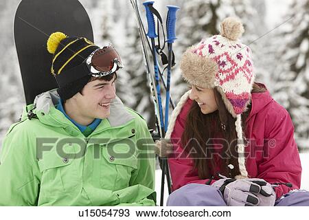 Stock Image - Two Teenagers On Ski Holiday In Mountains. Fotosearch