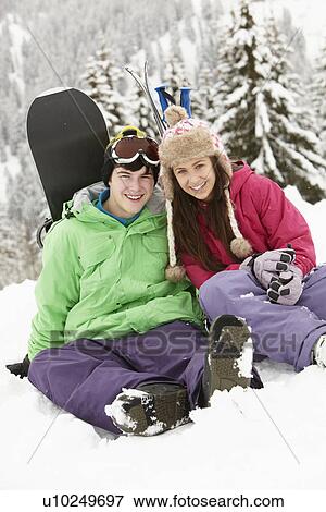 Stock Photo - Two Teenagers On Ski Holiday In Mountains. Fotosearch