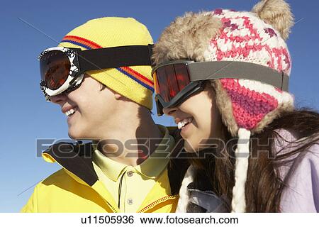 Stock Photograph - Two Teenagers On Ski Holiday In Mountains. Fotosearch