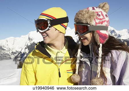 Stock Photograph - Two Teenagers On Ski Holiday In Mountains. Fotosearch