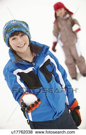 Stock Photo - Two Young Children Having Snowball Fight Wearing Woolly Hats. Fotosearch