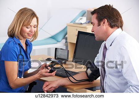UK doctor taking patient's blood pressure View Large Photo Image Stock Image - UK doctor taking patient's blood pressure. Fotosearch