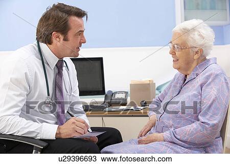 Stock Image - UK GP talking to senior woman patient. Fotosearch