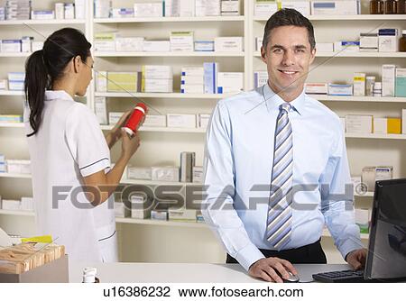 UK nurse and pharmacist working in pharmacy View Large Photo Image Stock Image - UK nurse and pharmacist working in pharmacy. Fotosearch
