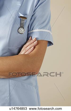 UK nurse standing with arms folded View Large Photo Image Stock Image - UK nurse standing with arms folded. Fotosearch