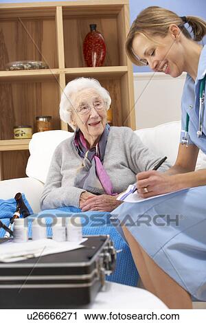 UK nurse visiting senior woman at home View Large Photo Image Stock Image - UK nurse visiting senior woman at home. Fotosearch