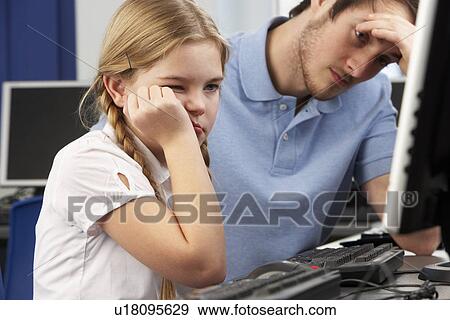 Stock Photo - Unhappy teacher and girl using computer in class. Fotosearch