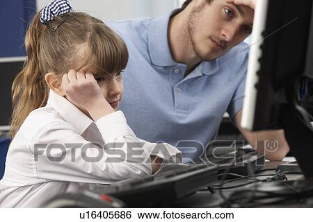 Unhappy teacher and girl using computer in class View Large Photo Image Stock Photograph - Unhappy teacher and girl using computer in class. Fotosearch