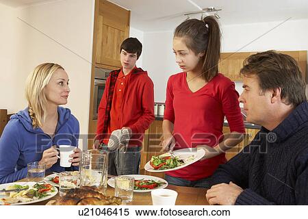 Unhelpful Teenage Clearing Up After Family Meal In Kitchen View Large Photo Image Stock Photography - Unhelpful Teenage Clearing Up After Family Meal In Kitchen. Fotosearch