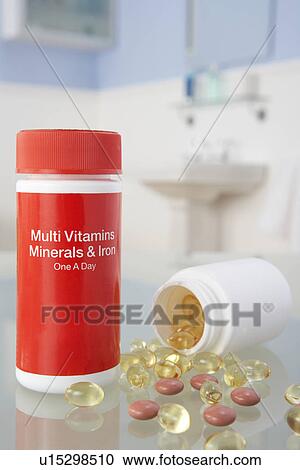 Stock Image - Vitamin pills on bathroom shelf. Fotosearch